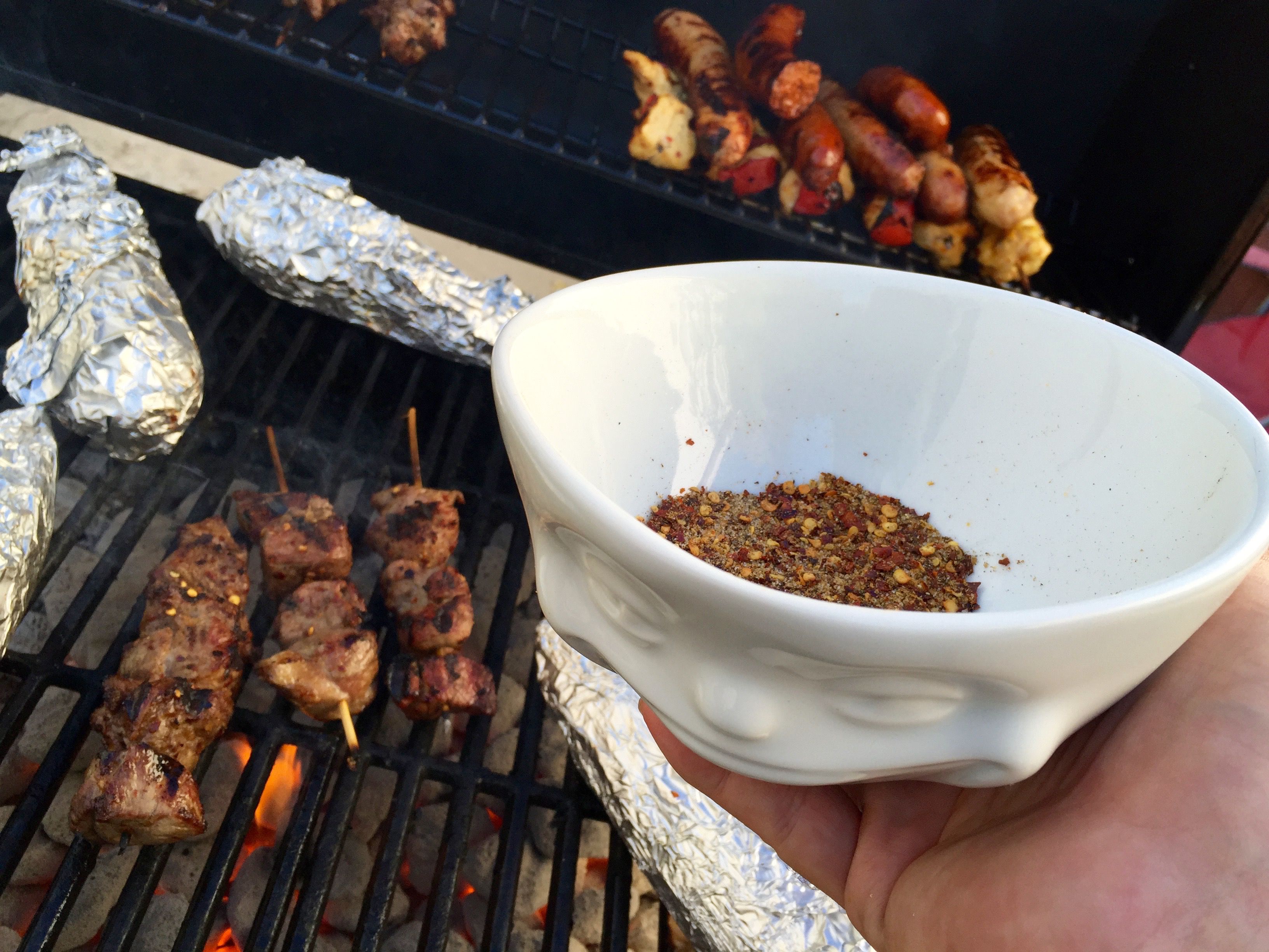 6. Arrange 5–6 pieces of lamb on each skewer and apply a generous dusting of dry spice mixture before throwing onto the grill. 